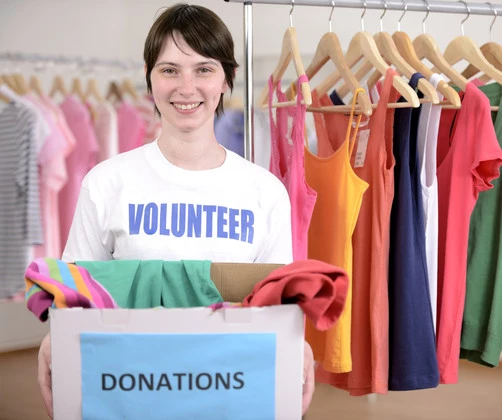 Happy volunteer with donation box